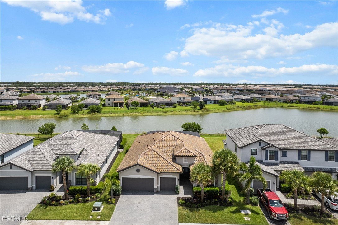 11559 Canopy Loop Fort Myers, FL 33913 - Photo 46 of 50 an aerial view of a house with a garden and lake view
