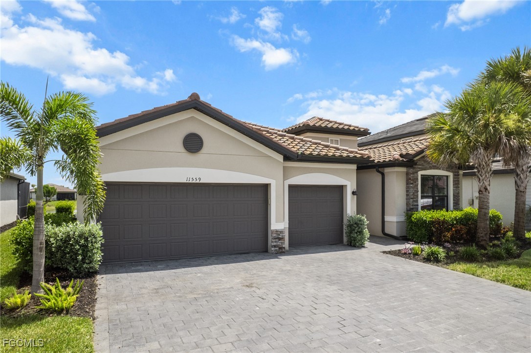 11559 Canopy Loop Fort Myers, FL 33913 - Photo 6 of 50 a front view of a house with a yard and garage