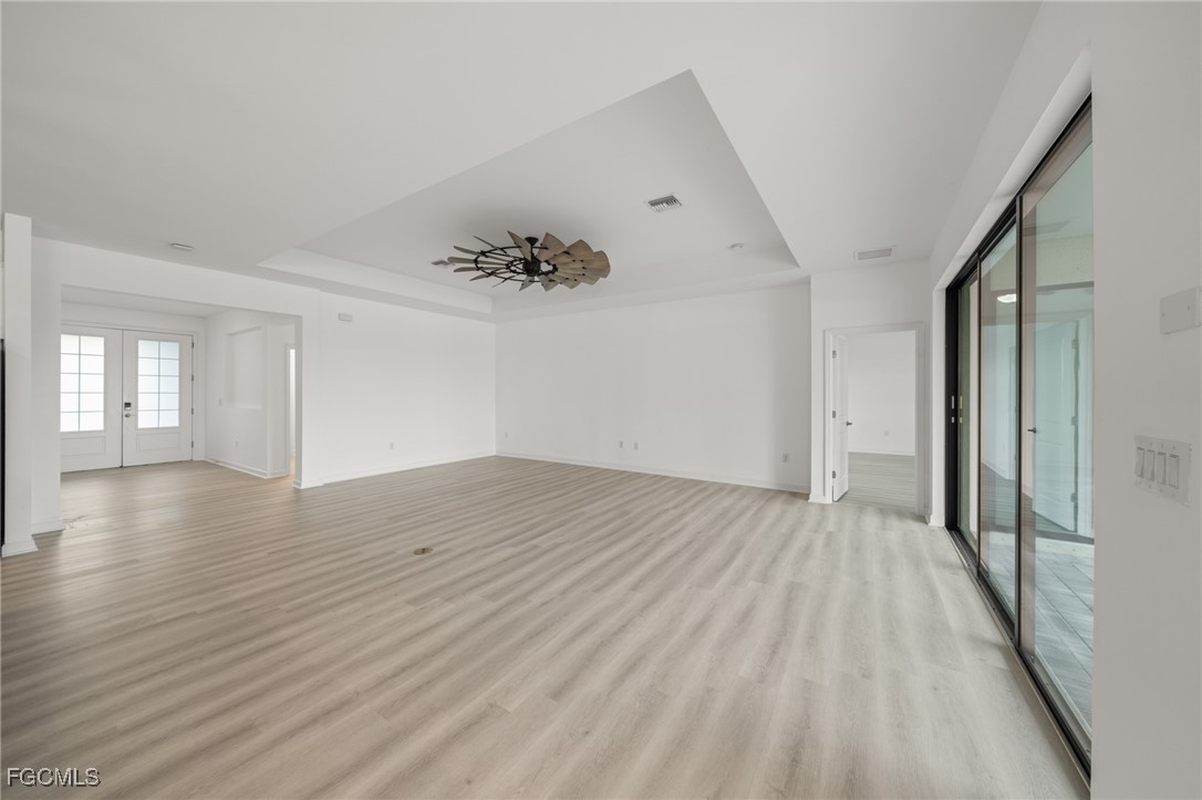 11559 Canopy Loop Fort Myers, FL 33913 - Photo 8 of 50 wooden floor in an empty room with a window