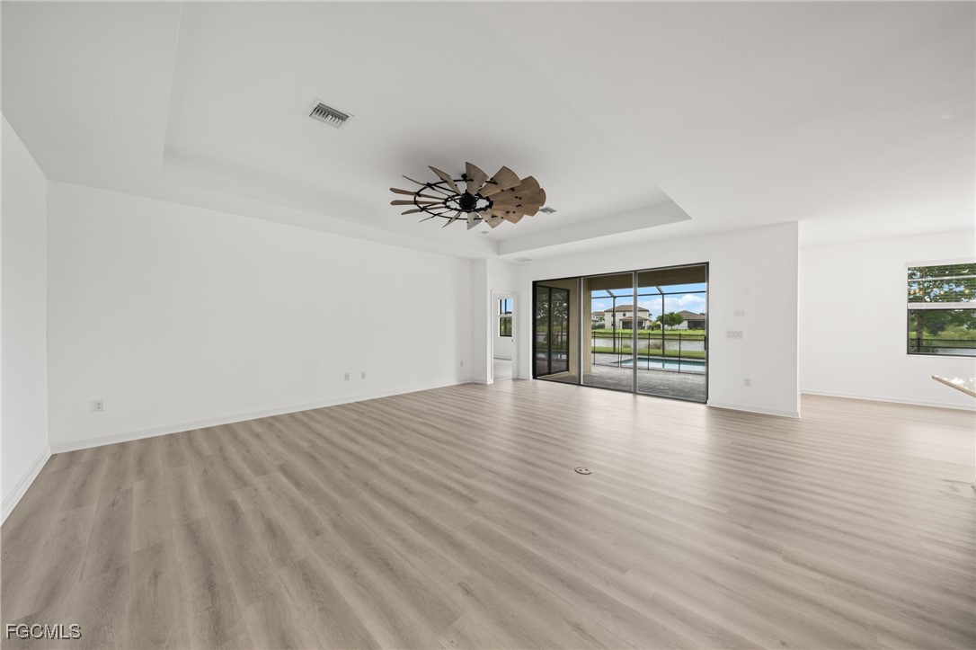 11559 Canopy Loop Fort Myers, FL 33913 - Photo 9 of 50 a view of an empty room with a window and wooden floor