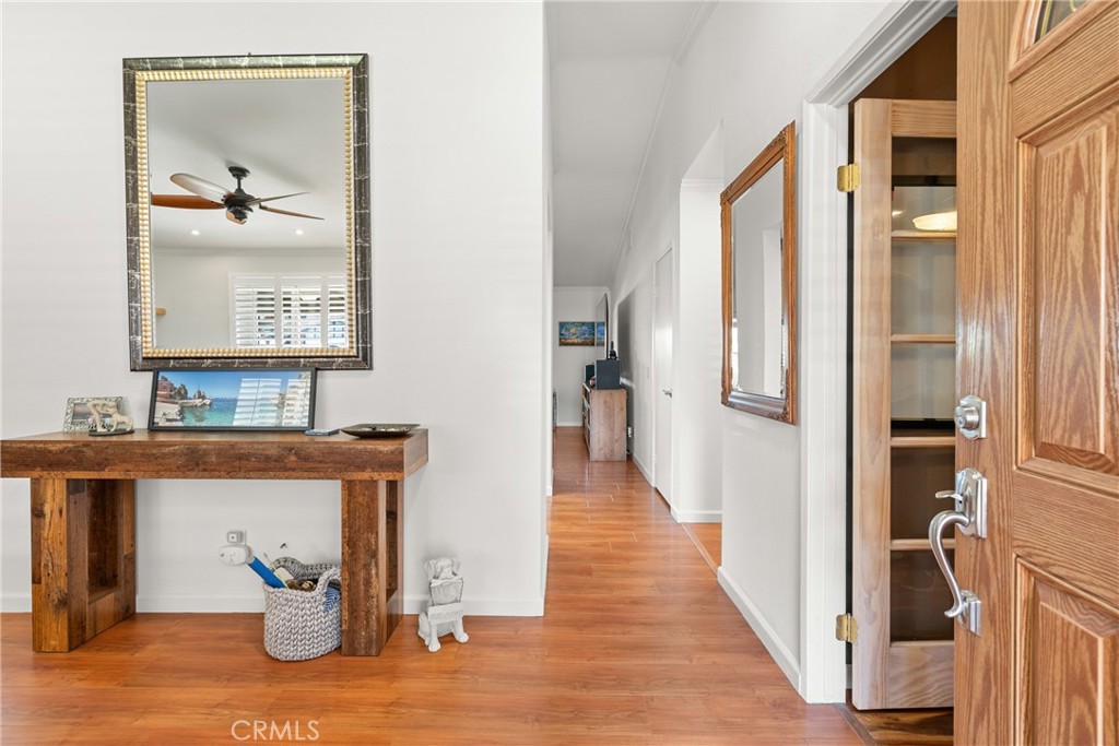 31436 Arrow Point Drive Castaic, CA 91384 - Photo 15 of 76 a view of a hallway with wooden floor and a mirror