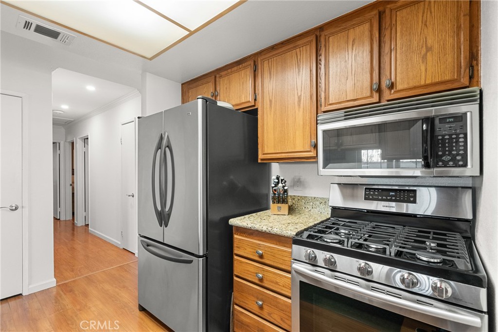 31436 Arrow Point Drive Castaic, CA 91384 - Photo 26 of 76 a kitchen with stainless steel appliances granite countertop a refrigerator stove and sink