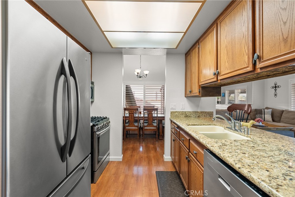 31436 Arrow Point Drive Castaic, CA 91384 - Photo 27 of 76 a kitchen with stainless steel appliances granite countertop a sink stove and refrigerator