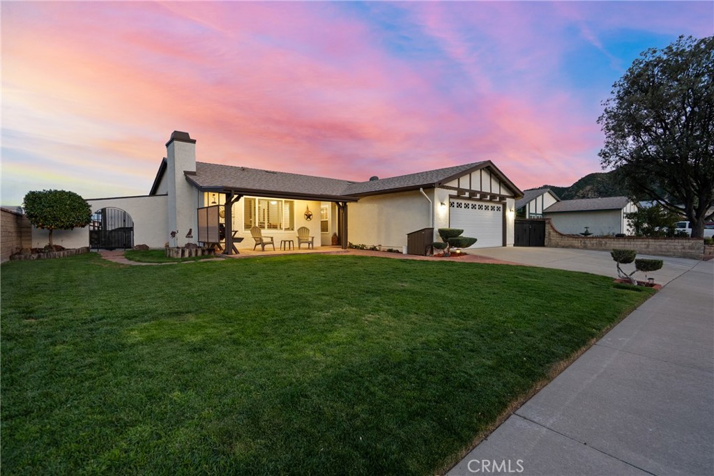 31436 Arrow Point Drive Castaic, CA 91384 - Photo 2 of 76 a front view of a house with a garden and yard