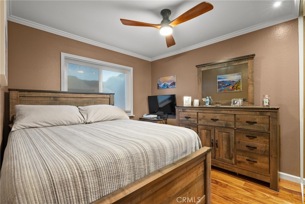 31436 Arrow Point Drive Castaic, CA 91384 - Photo 38 of 76 a bedroom with a bed and wooden floor