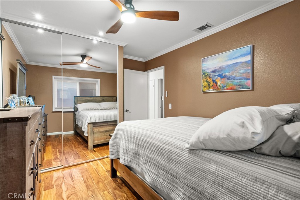 31436 Arrow Point Drive Castaic, CA 91384 - Photo 39 of 76 a bedroom with a bed and wooden floor