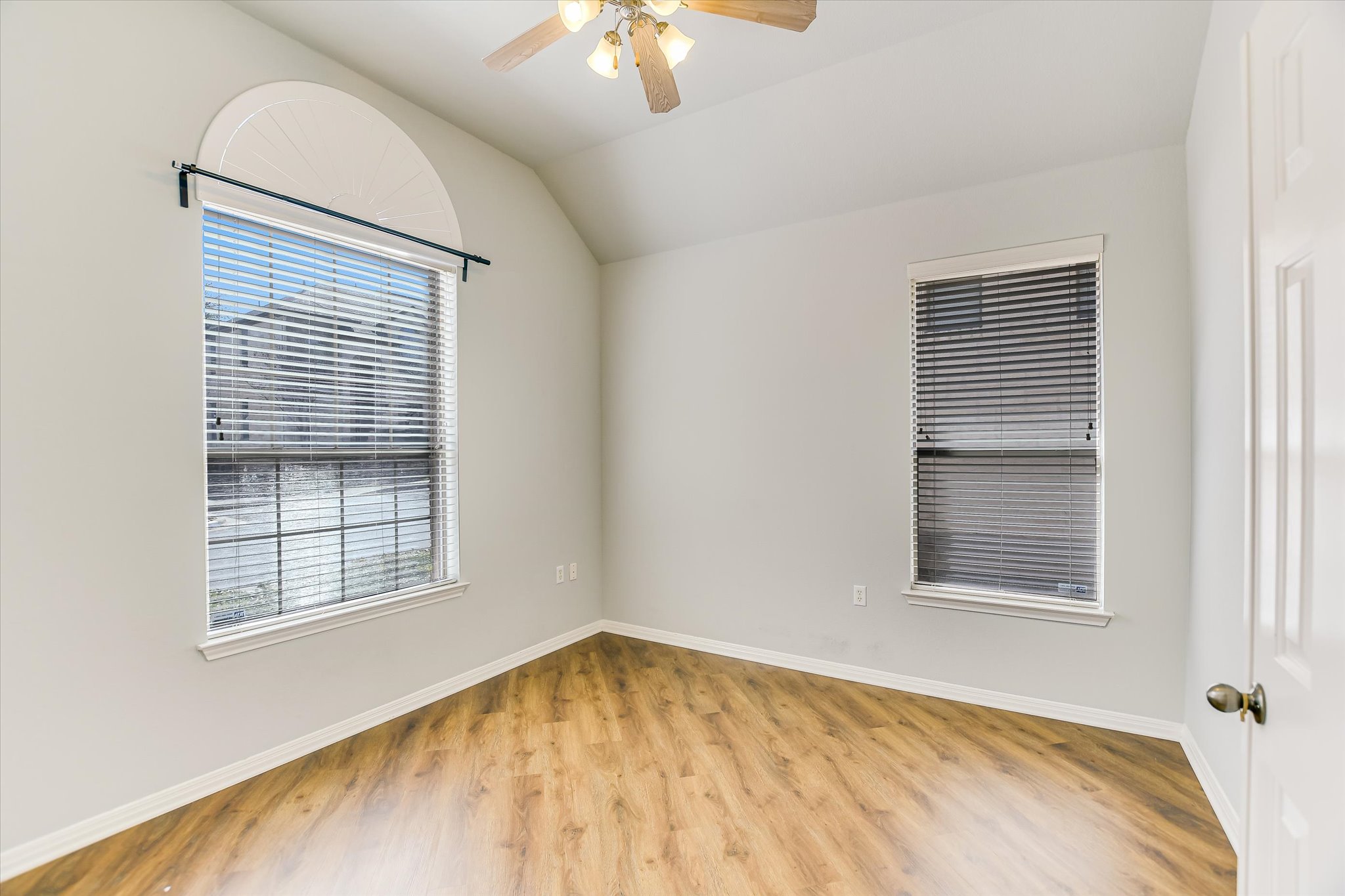 14100 Avery Ranch Boulevard, Unit 1101 Austin, TX 78717 - Photo 11 of 25 Spare room with a ceiling fan, vaulted ceiling, and light wood-style floors