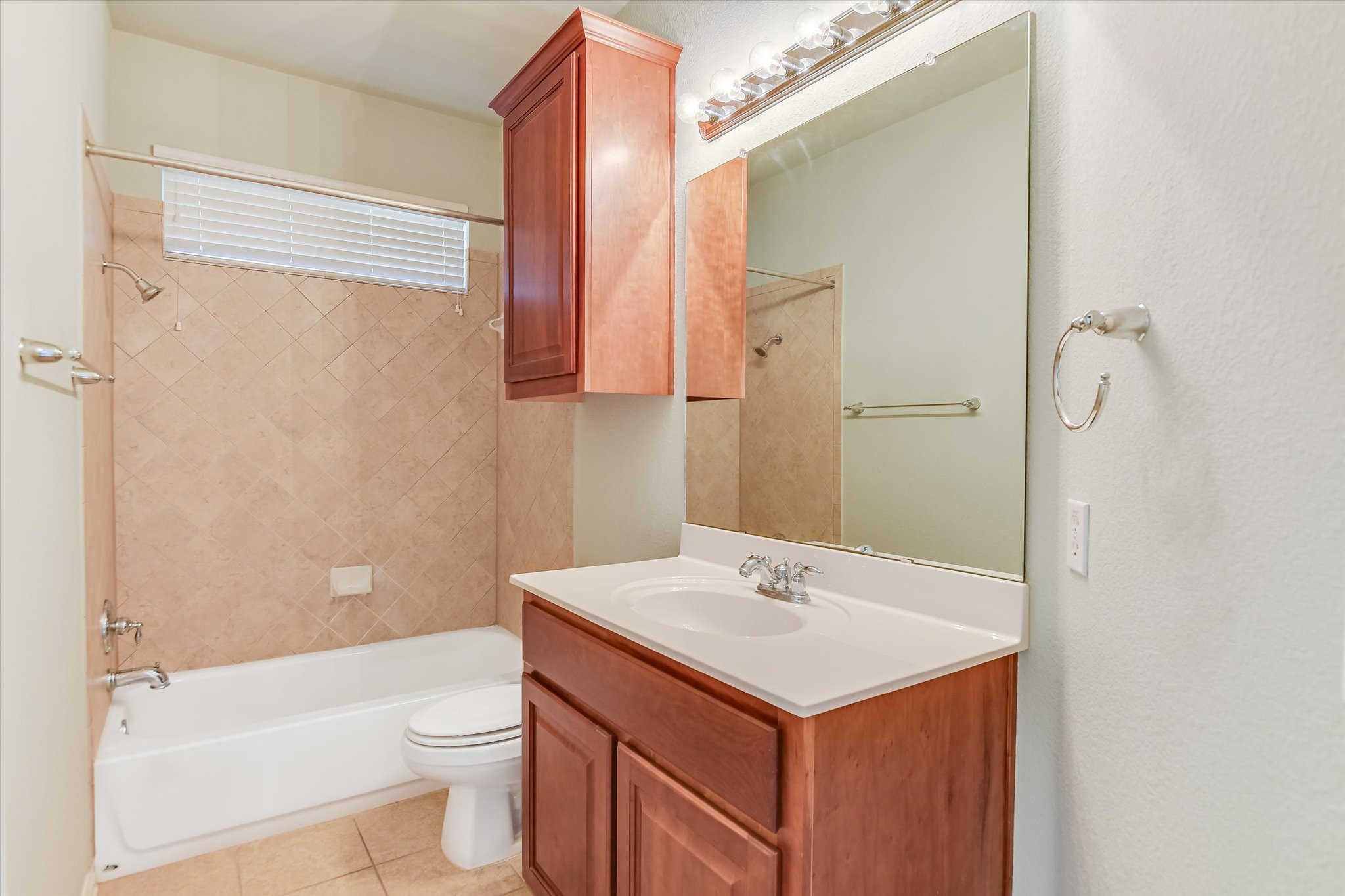 14100 Avery Ranch Boulevard, Unit 1101 Austin, TX 78717 - Photo 14 of 25 Full bath featuring vanity, washtub / shower combination, and light tile patterned floors