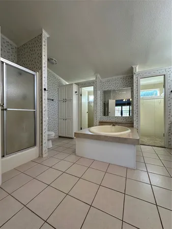 a large white kitchen with a sink and cabinets
