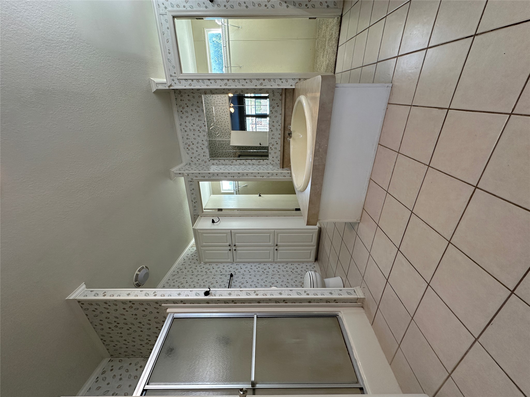 104 Ramirez Street Kyle, TX 78640 - Photo 13 of 31 a spacious bathroom with a shower and a mirror