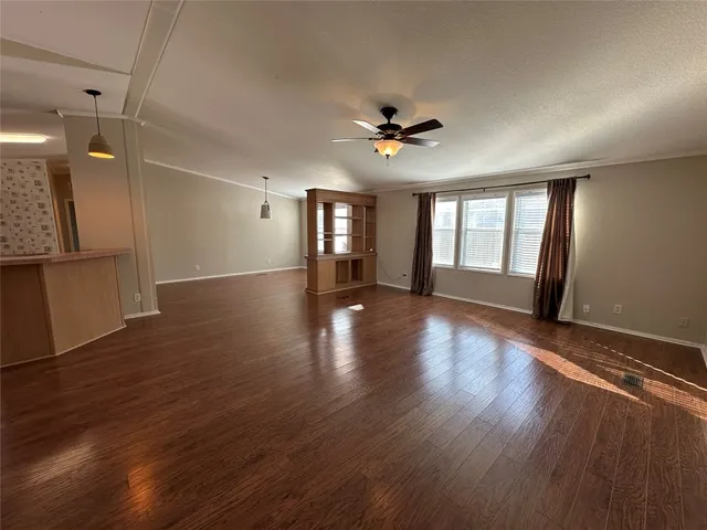 a room with wooden floor and window
