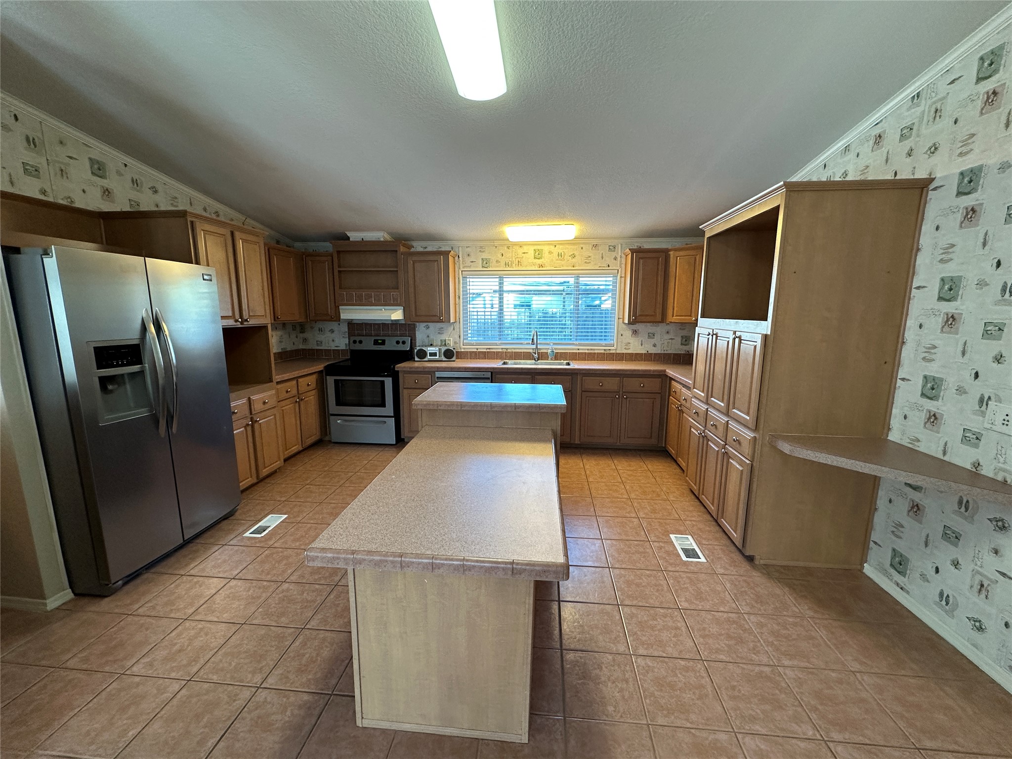 104 Ramirez Street Kyle, TX 78640 - Photo 9 of 31 a kitchen with granite countertop a refrigerator and a stove top oven