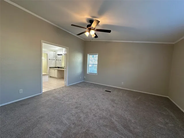 an empty room with closet and windows