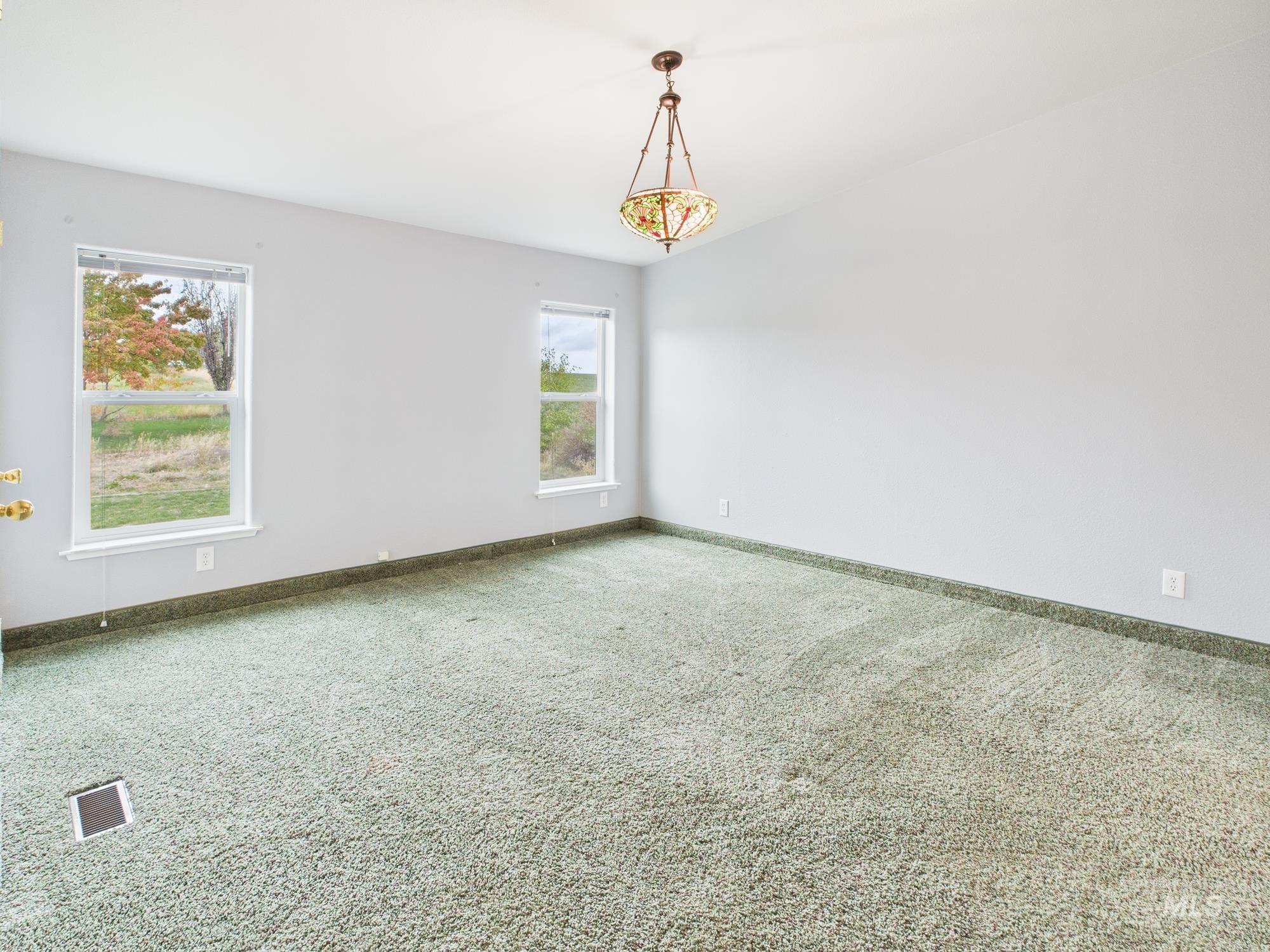 523 3rd Street Ferdinand, ID 83526 - Photo 13 of 41 Carpeted empty room featuring baseboards