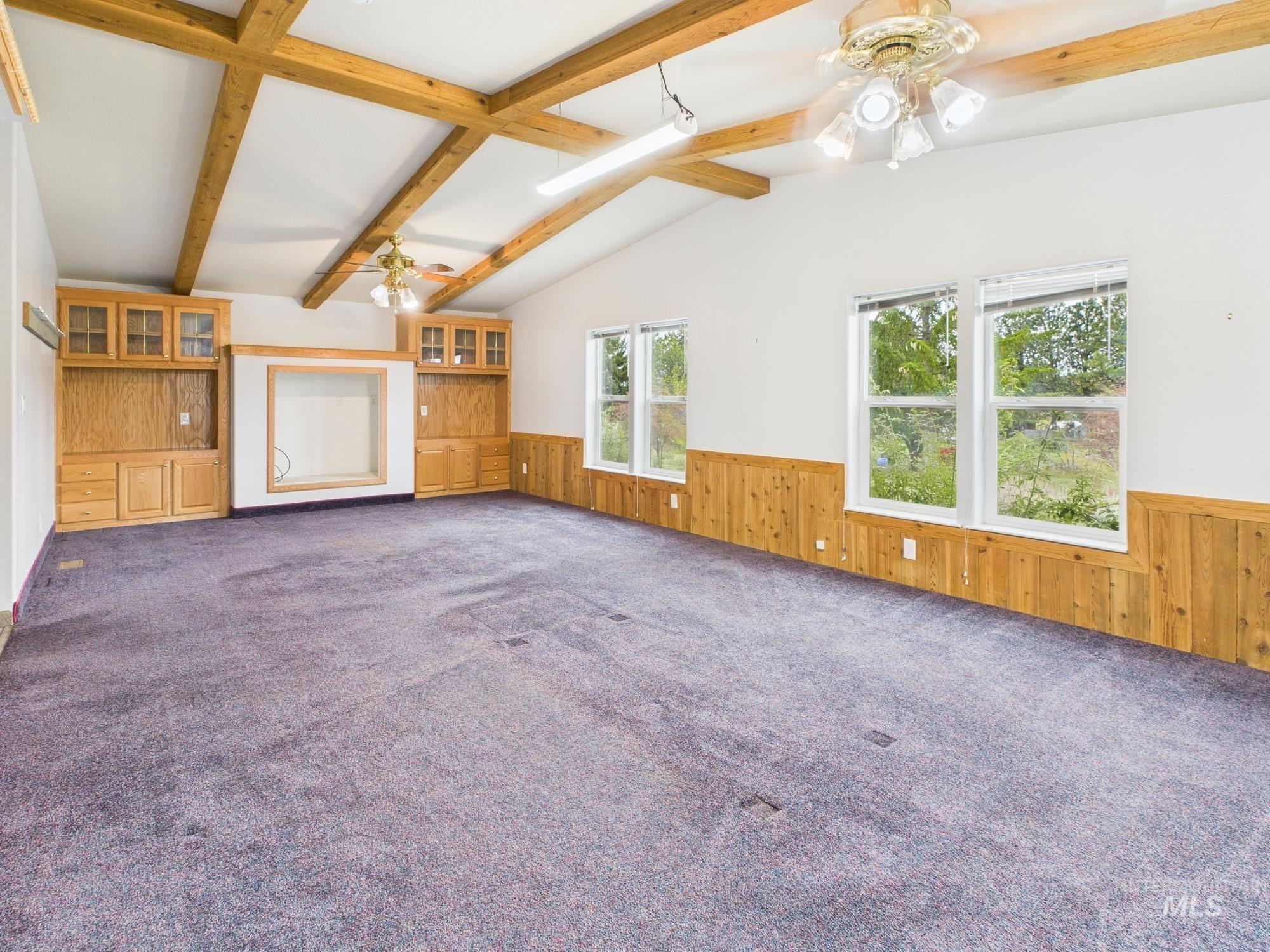 523 3rd Street Ferdinand, ID 83526 - Photo 24 of 41 wainscoting, ceiling fan, and dark carpet