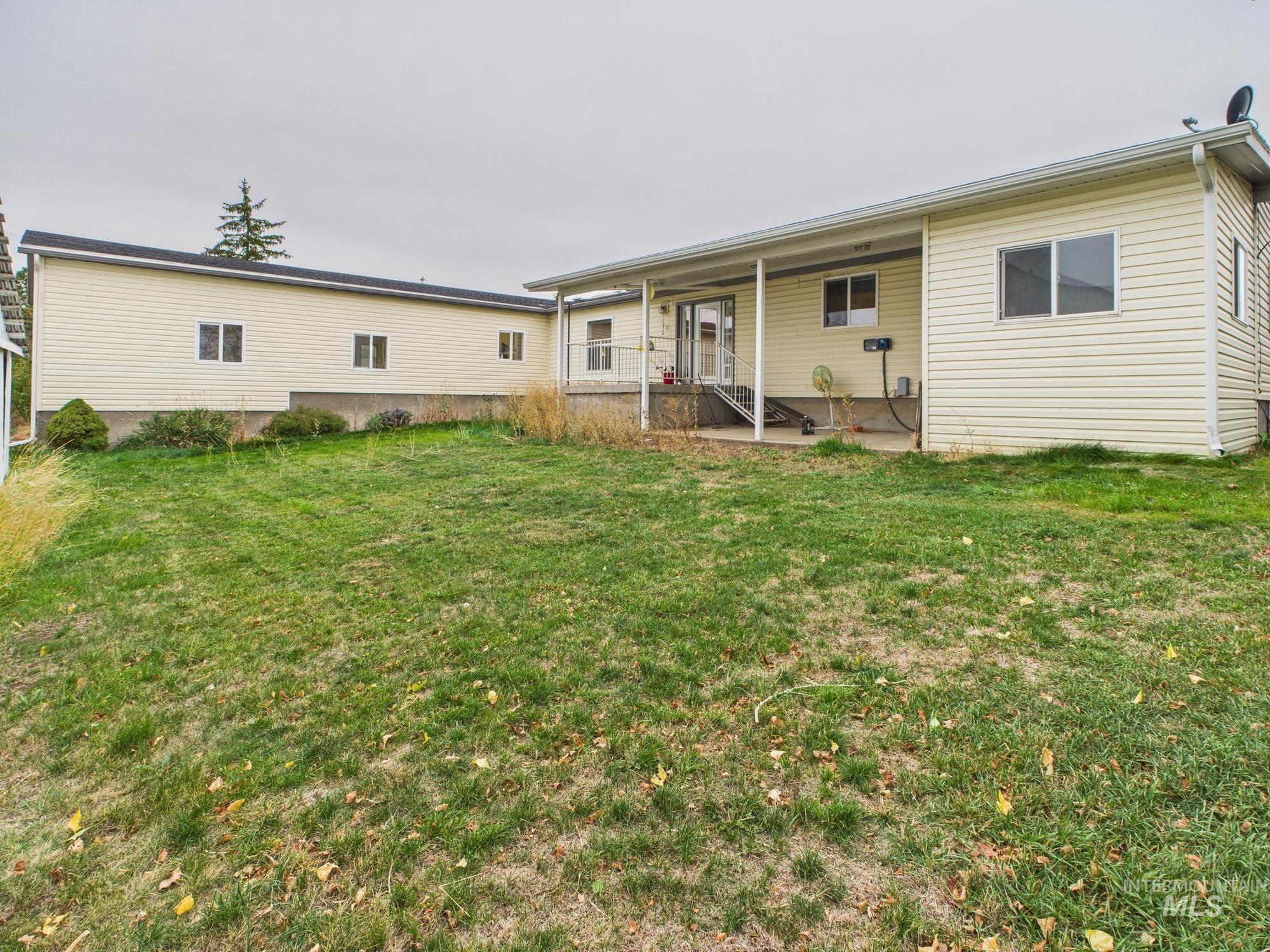 523 3rd Street Ferdinand, ID 83526 - Photo 29 of 41 Back of house featuring a lawn and a patio