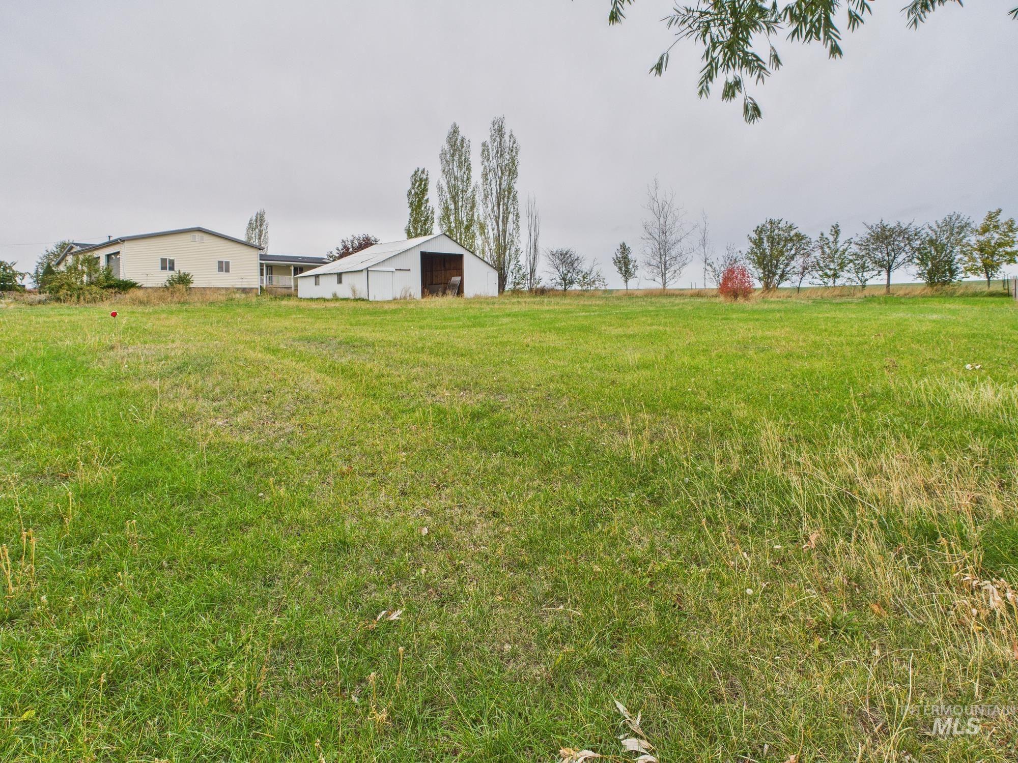 523 3rd Street Ferdinand, ID 83526 - Photo 33 of 41 View of green lawn with a pole building and an outbuilding