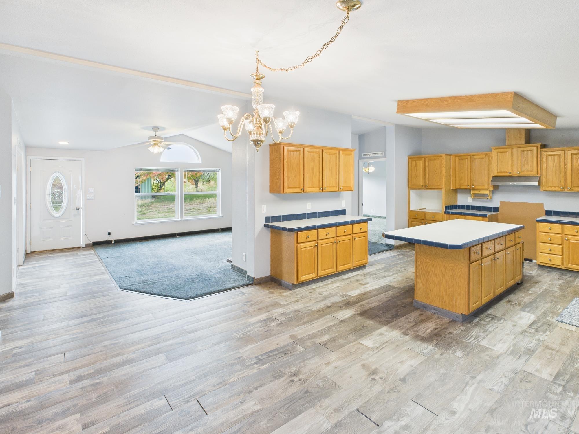 523 3rd Street Ferdinand, ID 83526 - Photo 39 of 41 Kitchen with open floor plan, a ceiling fan, light wood-style flooring, and a kitchen island