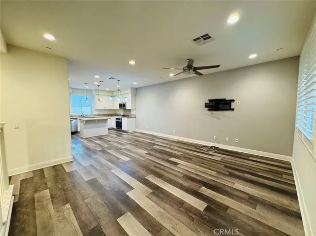 a view of a kitchen with a sink and a refrigerator
