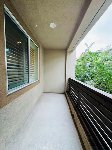 a kitchen with a refrigerator and white cabinets