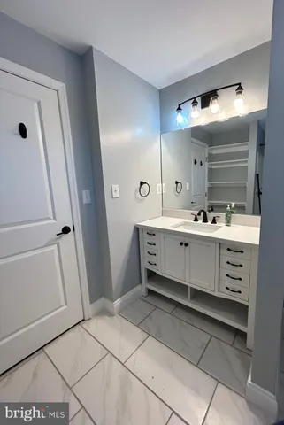 a bathroom with a sink a mirror and a vanity
