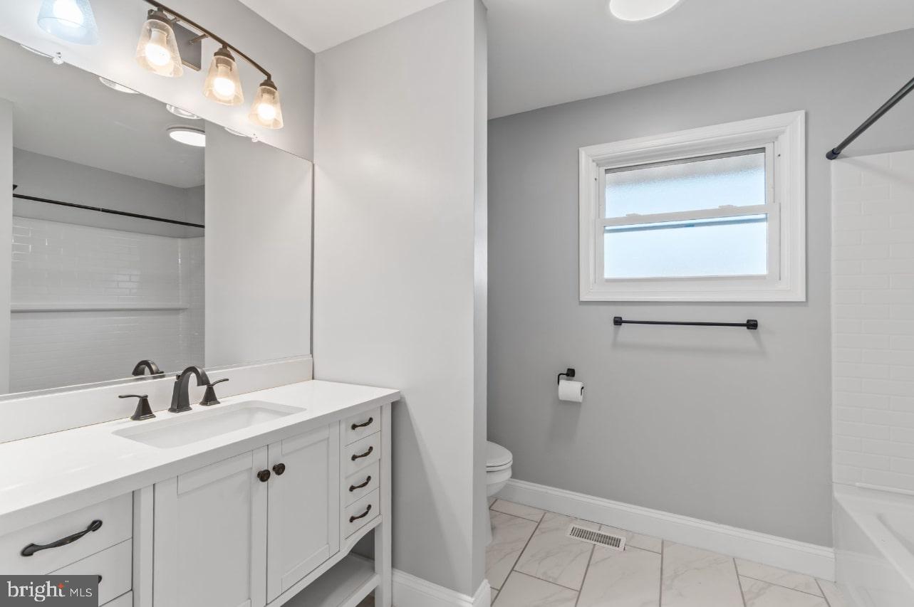 354 Berry Street Orange, VA 22960 - Photo 20 of 31 a bathroom with a double vanity sink a toilet and a mirror