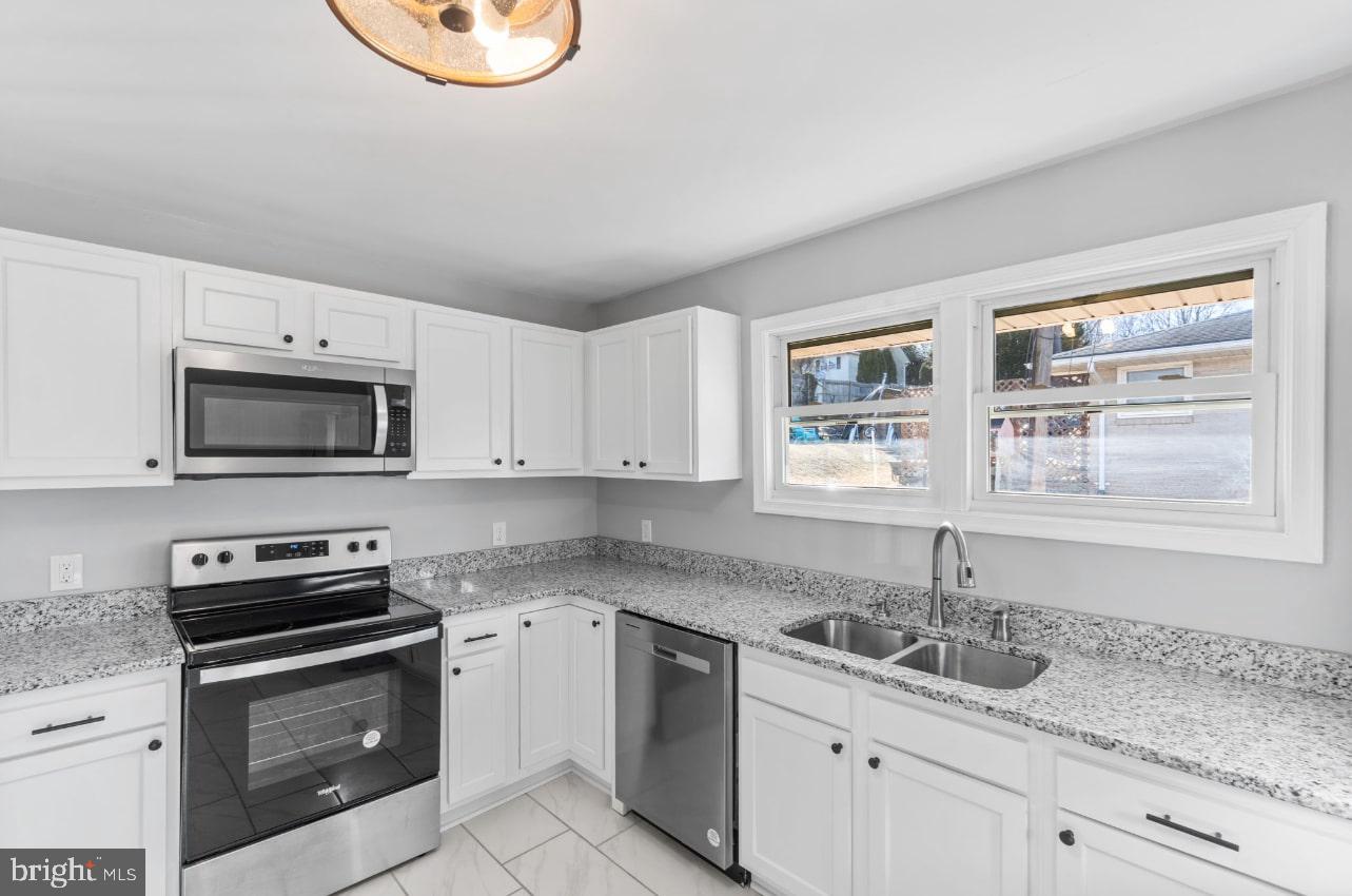 354 Berry Street Orange, VA 22960 - Photo 6 of 31 a kitchen with granite countertop a sink stainless steel appliances and cabinets