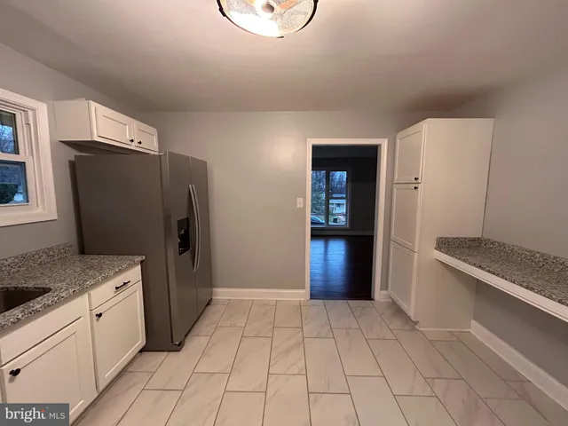 a kitchen with stainless steel appliances granite countertop a refrigerator and a stove