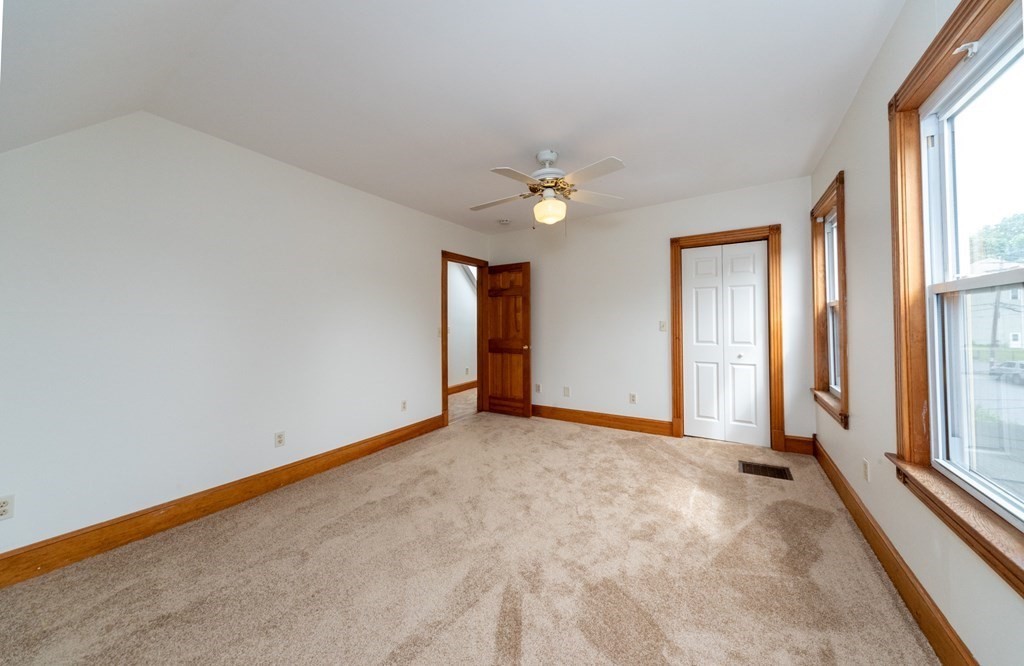 28 Branch Street Clinton, MA 01510 - Photo 18 of 30 an empty room with windows and chandelier fan