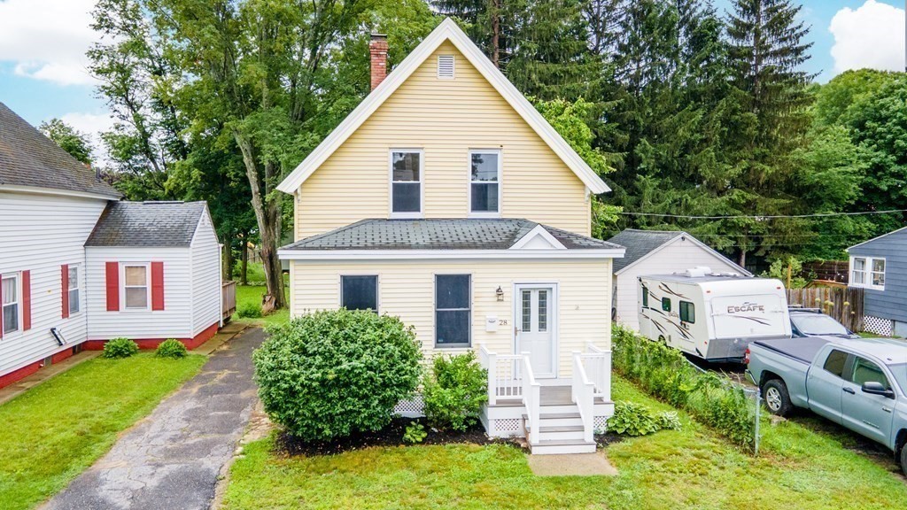 28 Branch Street Clinton, MA 01510 - Photo 2 of 30 a front view of a house with a yard and garage