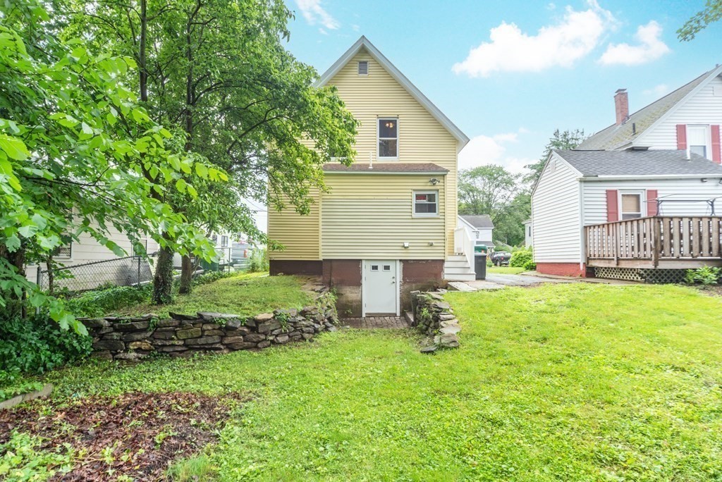 28 Branch Street Clinton, MA 01510 - Photo 27 of 30 a front view of a house with a yard and trees