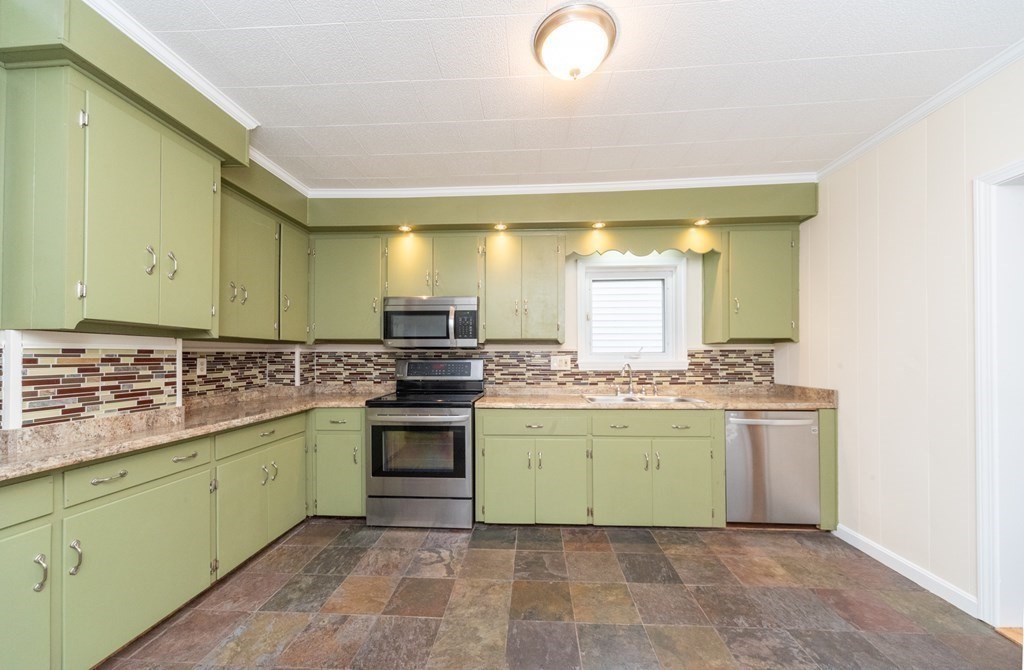 28 Branch Street Clinton, MA 01510 - Photo 4 of 30 a kitchen with a stove top oven sink and cabinets