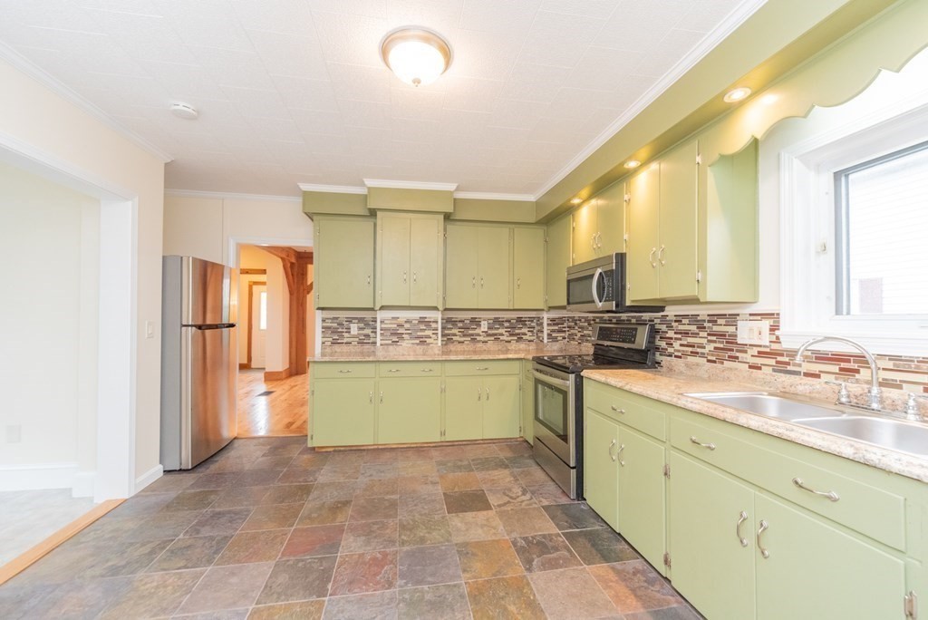 28 Branch Street Clinton, MA 01510 - Photo 5 of 30 a kitchen with a sink and refrigerator
