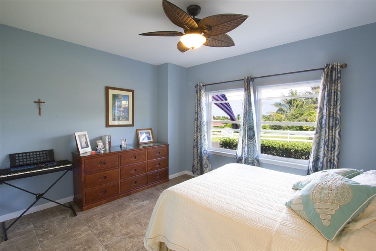81 North Holokai Road Haiku, HI 96708 - Photo 15 of 30 a bedroom with a bed and a large window