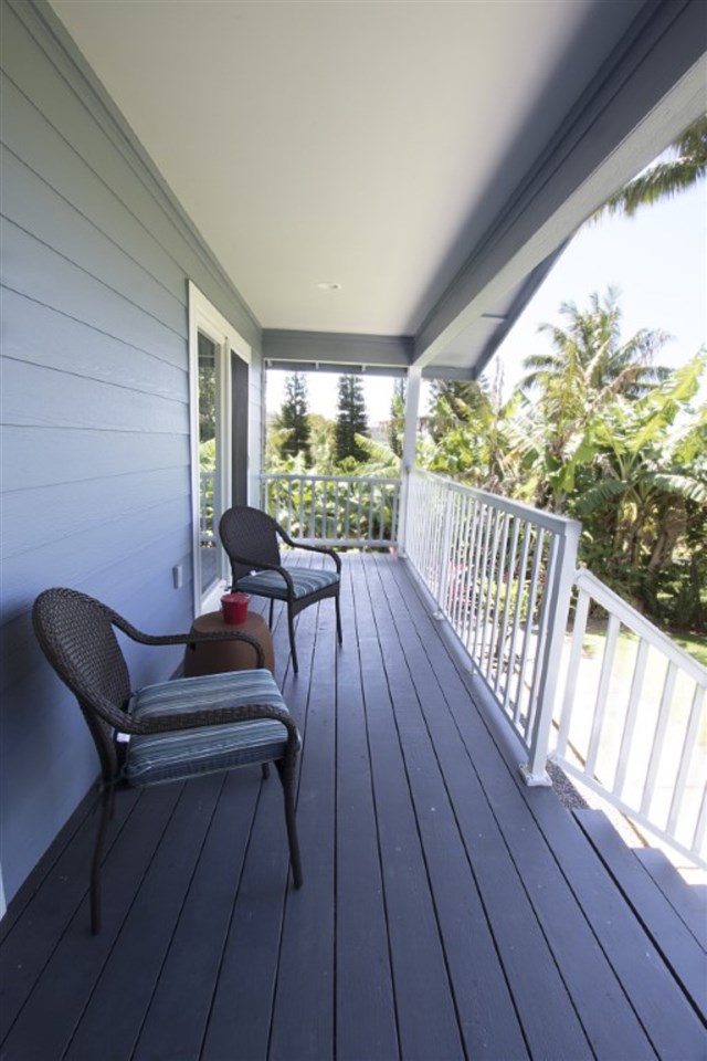 81 North Holokai Road Haiku, HI 96708 - Photo 26 of 30 a balcony with wooden floor and outdoor seating