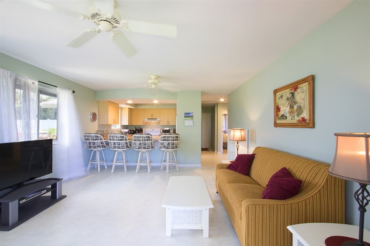 81 North Holokai Road Haiku, HI 96708 - Photo 27 of 30 a living room with furniture and a flat screen tv