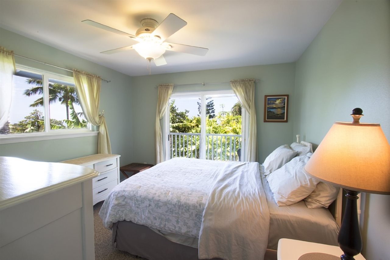 81 North Holokai Road Haiku, HI 96708 - Photo 29 of 30 a bedroom with a bed and dresser with mirror