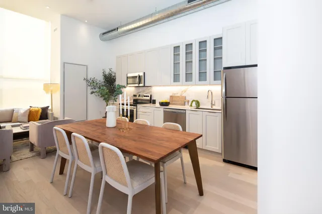a kitchen with a table and chairs