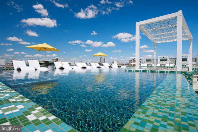 a swimming pool with outdoor seating and yard