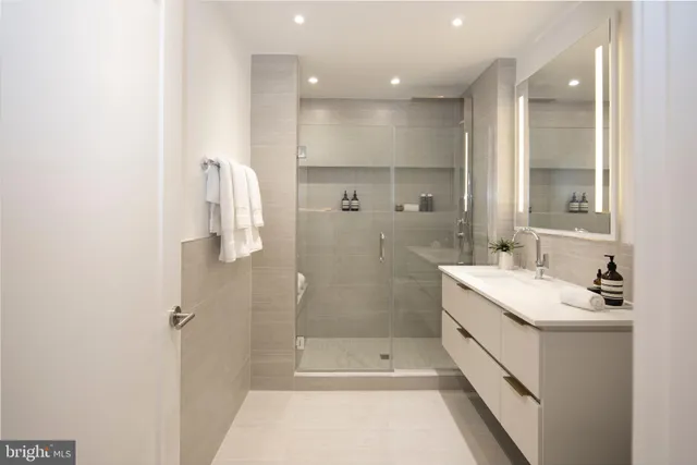 a bathroom with a sink a shower and a mirror