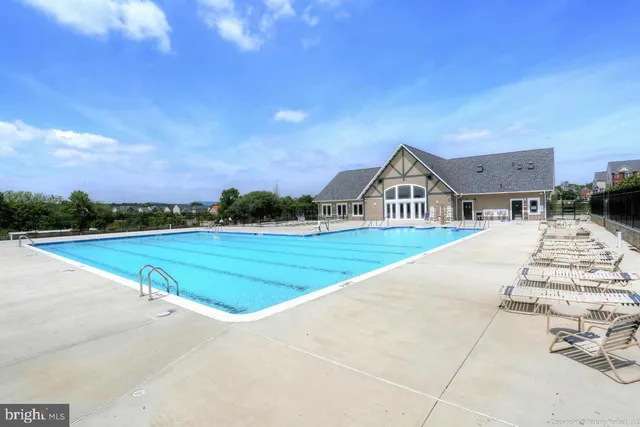 a view of house with outdoor space and sitting area