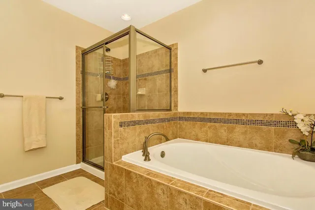 a bathroom with a tub a sink and a shower