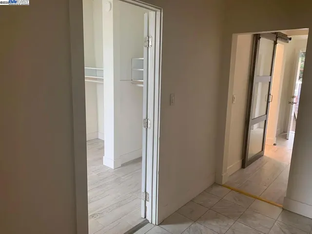 a view of a hallway with wooden floor