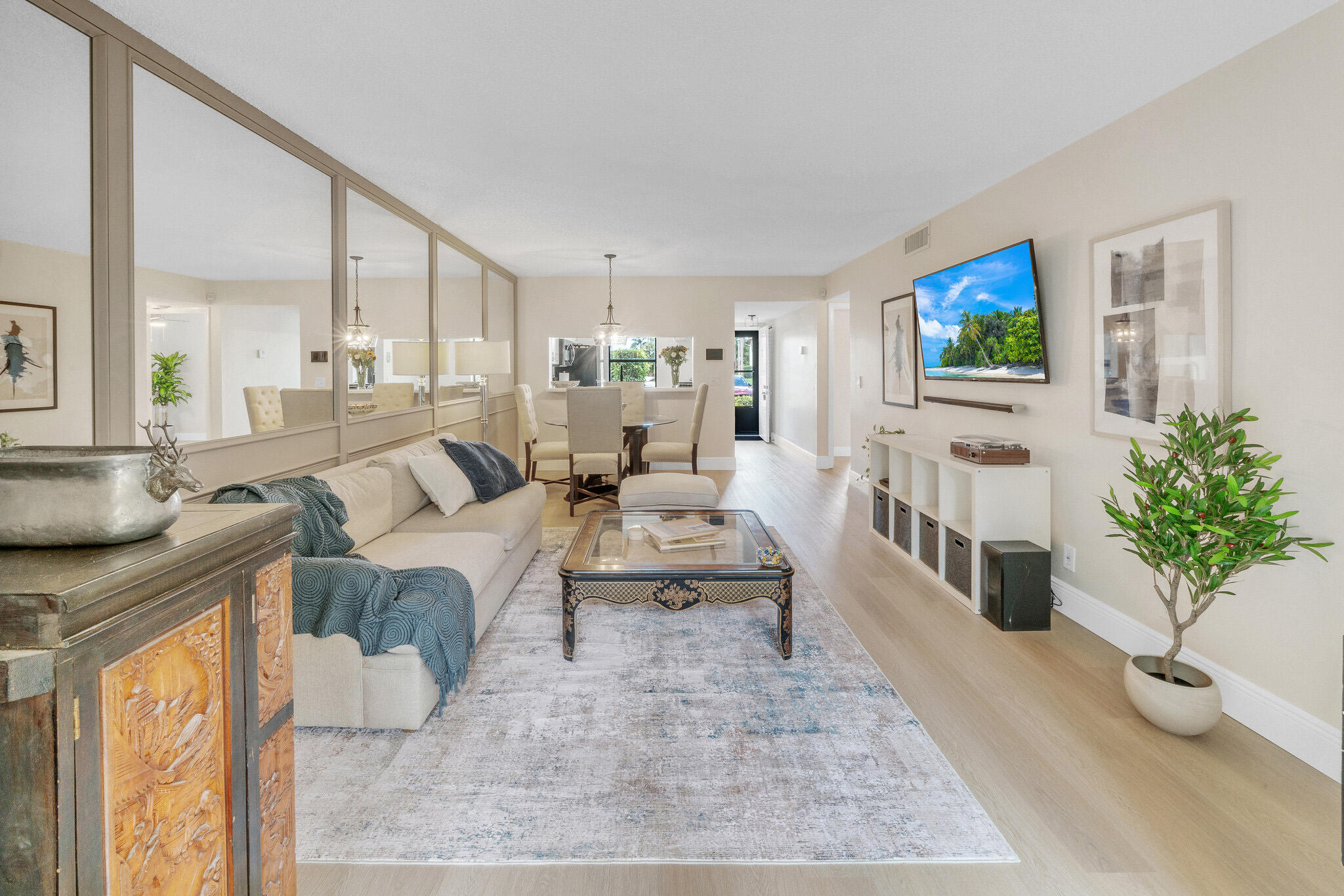 22136 Palms Way, Unit 103 Boca Raton, FL 33433 - Photo 17 of 42 a living room with furniture and a flat screen tv