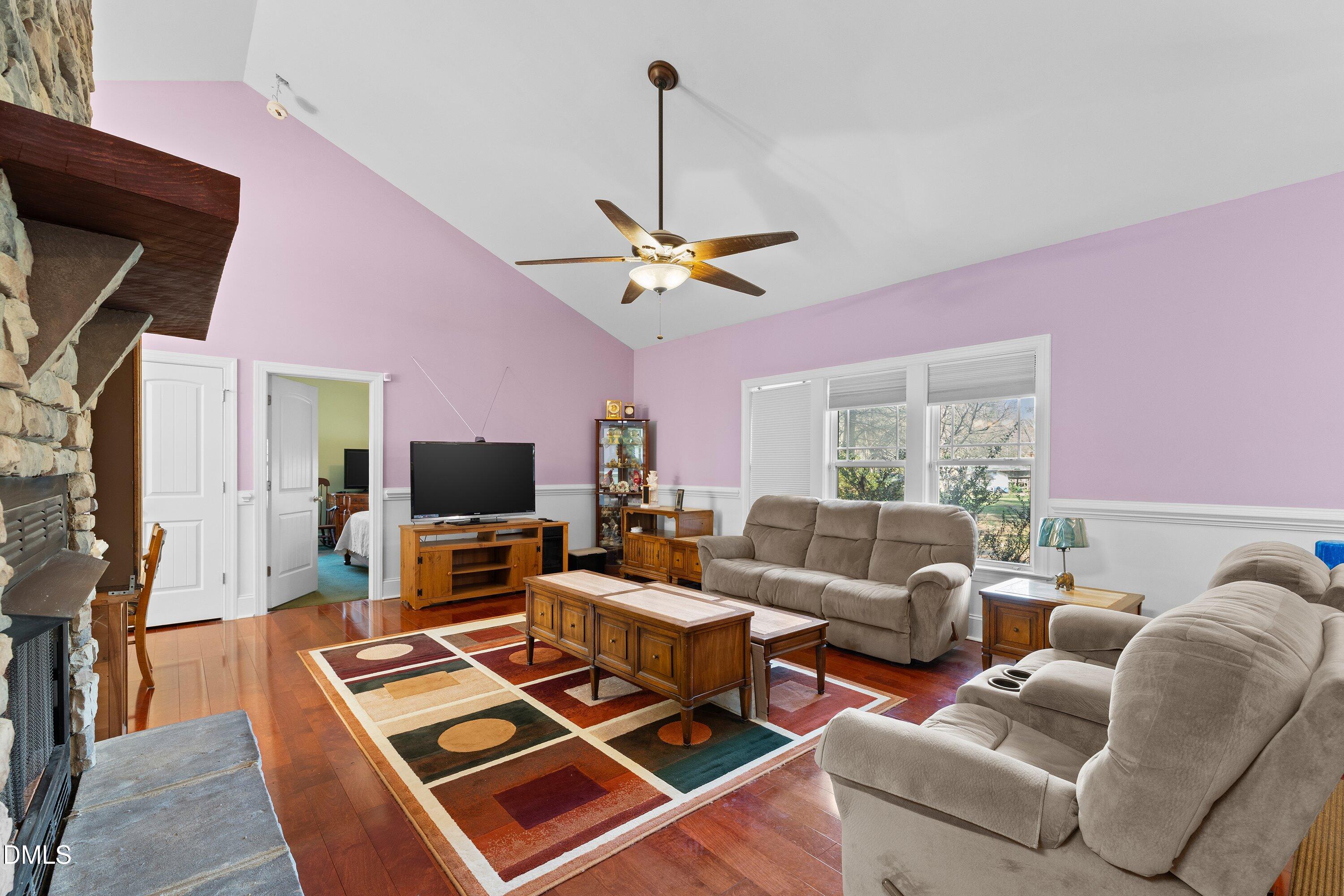 9713 Lake Wheeler Road Raleigh, NC 27603 - Photo 9 of 18 a living room with furniture a flat screen tv and a table