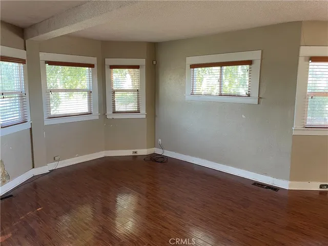 an empty room with wooden floor