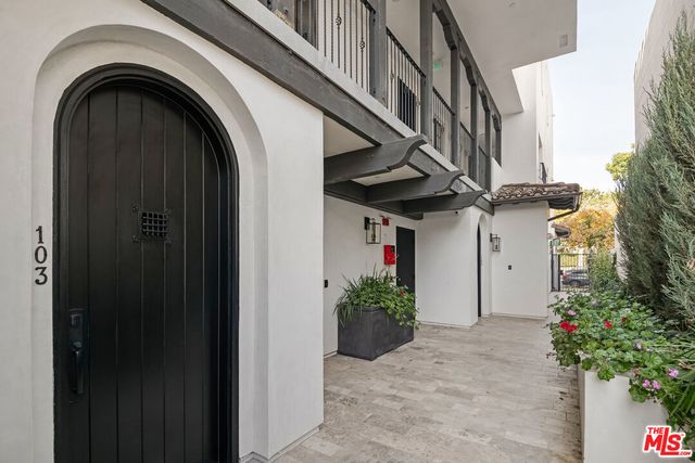 a view of entryway with flower plants