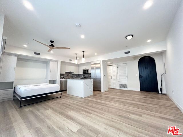 a living room with furniture and kitchen view