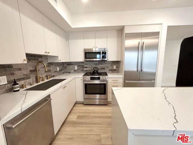 a kitchen with a sink a stove and refrigerator