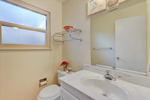 a view of a bedroom with a ceiling fan and a window